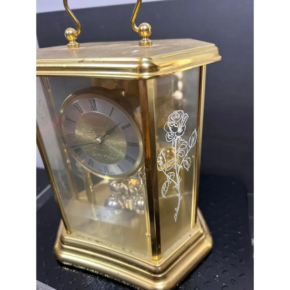 vintage German mantle clock with gold hexagonal glass case and etched roses.